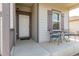 Cozy front porch with outdoor seating next to the front door at 7414 Blue River Ave, Frederick, CO 80530