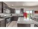 Kitchen with gas range, island with seating, countertops, and stainless steel appliances at 7414 Blue River Ave, Frederick, CO 80530