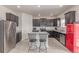 Well-lit kitchen boasts stainless steel appliances, a center island, and ample cabinet space at 7414 Blue River Ave, Frederick, CO 80530