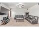 Inviting living room featuring comfortable seating, a ceiling fan, and a media center at 7414 Blue River Ave, Frederick, CO 80530