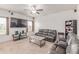 Comfortable living room with plush seating, a ceiling fan, and a mounted TV at 7414 Blue River Ave, Frederick, CO 80530