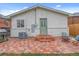 Backyard brick patio and a lush grassy area, perfect for outdoor relaxation at 3619 N York St, Denver, CO 80205