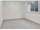 Bright bedroom with neutral tile flooring and a large window, offering a clean and simple aesthetic at 3619 N York St, Denver, CO 80205
