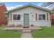 Charming bungalow with updated facade, lovely porch decor, and well-manicured lawn at 3619 N York St, Denver, CO 80205