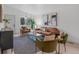 Bright living room features modern decor, large window and hardwood floors at 3619 N York St, Denver, CO 80205