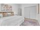 Bright main bedroom with a walk-in closet, modern art, and plenty of natural light at 3619 N York St, Denver, CO 80205