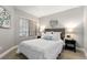 Bedroom features a queen bed, soft lighting, and a decorative round mirror at 4713 Spine Rd # D, Boulder, CO 80301