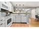 Modern kitchen with white cabinets, appliances, and a seamless connection to living spaces at 4713 Spine Rd # D, Boulder, CO 80301