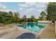 Community swimming pool surrounded by lush greenery, lounge chairs, and tables at 4713 Spine Rd # D, Boulder, CO 80301