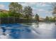Community tennis court with a pristine blue surface and black fencing, providing a recreational amenity at 4713 Spine Rd # D, Boulder, CO 80301