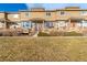 Charming townhouse showcasing a well-maintained lawn and inviting front porch at 9752 Dahlia Ln, Thornton, CO 80229