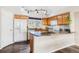 Kitchen features granite countertops, wood cabinets, and stainless steel appliances at 9752 Dahlia Ln, Thornton, CO 80229