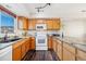 Modern kitchen featuring granite countertops and oak cabinets at 9752 Dahlia Ln, Thornton, CO 80229