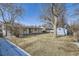 Wide shot of the backyard with a shed, snow on the side of the fence, and covered patio at 2582 S Birch St, Denver, CO 80222