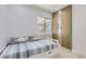 Bedroom with a twin bed, blue striped bedding and a mirrored closet at 2582 S Birch St, Denver, CO 80222