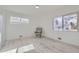 Bright bedroom featuring hardwood floors, two large windows, and a decorative chair at 2582 S Birch St, Denver, CO 80222