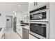 Kitchen featuring stainless steel appliances, subway tile backsplash, and marble flooring at 2582 S Birch St, Denver, CO 80222