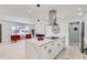 Modern kitchen with waterfall island, stainless steel hood, and adjacent living room with large windows at 2582 S Birch St, Denver, CO 80222