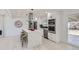 Bright kitchen featuring stainless steel appliances, island with marble countertop and seating at 2582 S Birch St, Denver, CO 80222