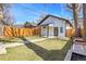 A sprawling backyard lawn, featuring a patio, and modern wooden fence, perfect for outdoor activities at 1317 Monroe St, Denver, CO 80206