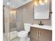 Bathroom with a sleek glass shower, modern tiling, and contemporary fixtures at 1317 Monroe St, Denver, CO 80206