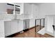 Well-lit kitchen featuring white cabinets, stainless steel dishwasher, and marble countertops at 1317 Monroe St, Denver, CO 80206