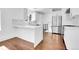 Contemporary kitchen with stainless steel fridge, stone countertops, and wooden floors at 1317 Monroe St, Denver, CO 80206