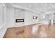 Bright living room with hardwood floors, fireplace, and open layout to the modern kitchen at 1317 Monroe St, Denver, CO 80206