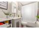 The bathroom has a modern single sink vanity, a framed mirror, and a shower tub at 4685 Wadsworth Blvd, Wheat Ridge, CO 80033