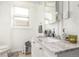 Bright bathroom showcasing a marble countertop vanity, fixtures, and a classic toilet at 4685 Wadsworth Blvd, Wheat Ridge, CO 80033