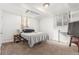 Simple bedroom with a bed, carpeted floors, two windows, and a radiator at 4685 Wadsworth Blvd, Wheat Ridge, CO 80033