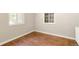 Clean bedroom with hardwood floors and natural light from windows at 4685 Wadsworth Blvd, Wheat Ridge, CO 80033