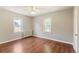 Bedroom with refinished wood floors, fresh paint, and vintage radiator at 4685 Wadsworth Blvd, Wheat Ridge, CO 80033