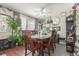 Formal dining room with wooden table, chairs, ceiling fan, and abundant natural light at 4685 Wadsworth Blvd, Wheat Ridge, CO 80033