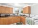 Kitchen with wood cabinets, a window above the sink, and a white oven at 4685 Wadsworth Blvd, Wheat Ridge, CO 80033