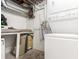 Basement laundry room with washer and dryer, exposed pipes, and concrete walls at 4685 Wadsworth Blvd, Wheat Ridge, CO 80033