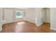 Bright living room featuring wood floors, built-in cabinets, fresh paint and natural light at 4685 Wadsworth Blvd, Wheat Ridge, CO 80033