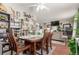 The living room features a dark wooden table, a fan, and decor with a view to another room at 4685 Wadsworth Blvd, Wheat Ridge, CO 80033