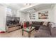 Inviting living room space with an oversized sectional sofa, TV, and built-in shelving at 4685 Wadsworth Blvd, Wheat Ridge, CO 80033