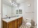 Bathroom featuring double sinks and decorative tile flooring at 5705 N Genoa Way # 308, Aurora, CO 80019
