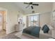 Bright bedroom featuring a ceiling fan, slider to the outside and neutral carpeting at 5705 N Genoa Way # 308, Aurora, CO 80019