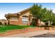 View of the clubhouse from the front, surrounded by a green lawn at 5705 N Genoa Way # 308, Aurora, CO 80019