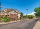 Welcoming entrance sign to the First Creek Farm community showing brick architecture and a security gate at 5705 N Genoa Way # 308, Aurora, CO 80019