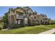 A multi-story condo building with well-maintained landscaping on a sunny day at 5705 N Genoa Way # 308, Aurora, CO 80019