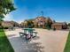 Outdoor picnic area with tables, ideal for enjoying meals and gatherings in a community setting at 5705 N Genoa Way # 308, Aurora, CO 80019