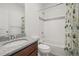 A bathroom features a shower and tub combination with a neutral-toned vanity at 5074 Yosemite Ct # 1, Denver, CO 80238