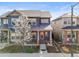 Charming two-story home with a welcoming front porch and a beautiful flowering tree in the front yard at 5074 Yosemite Ct # 1, Denver, CO 80238