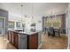 Open kitchen featuring island seating, a dining area, and a view into the living room at 5074 Yosemite Ct # 1, Denver, CO 80238