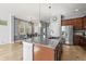Spacious kitchen features a granite island, stainless steel appliances, and wood cabinets at 5074 Yosemite Ct # 1, Denver, CO 80238