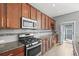 Well-equipped kitchen featuring stainless steel appliances, granite countertops, and plenty of cabinet space at 5074 Yosemite Ct # 1, Denver, CO 80238